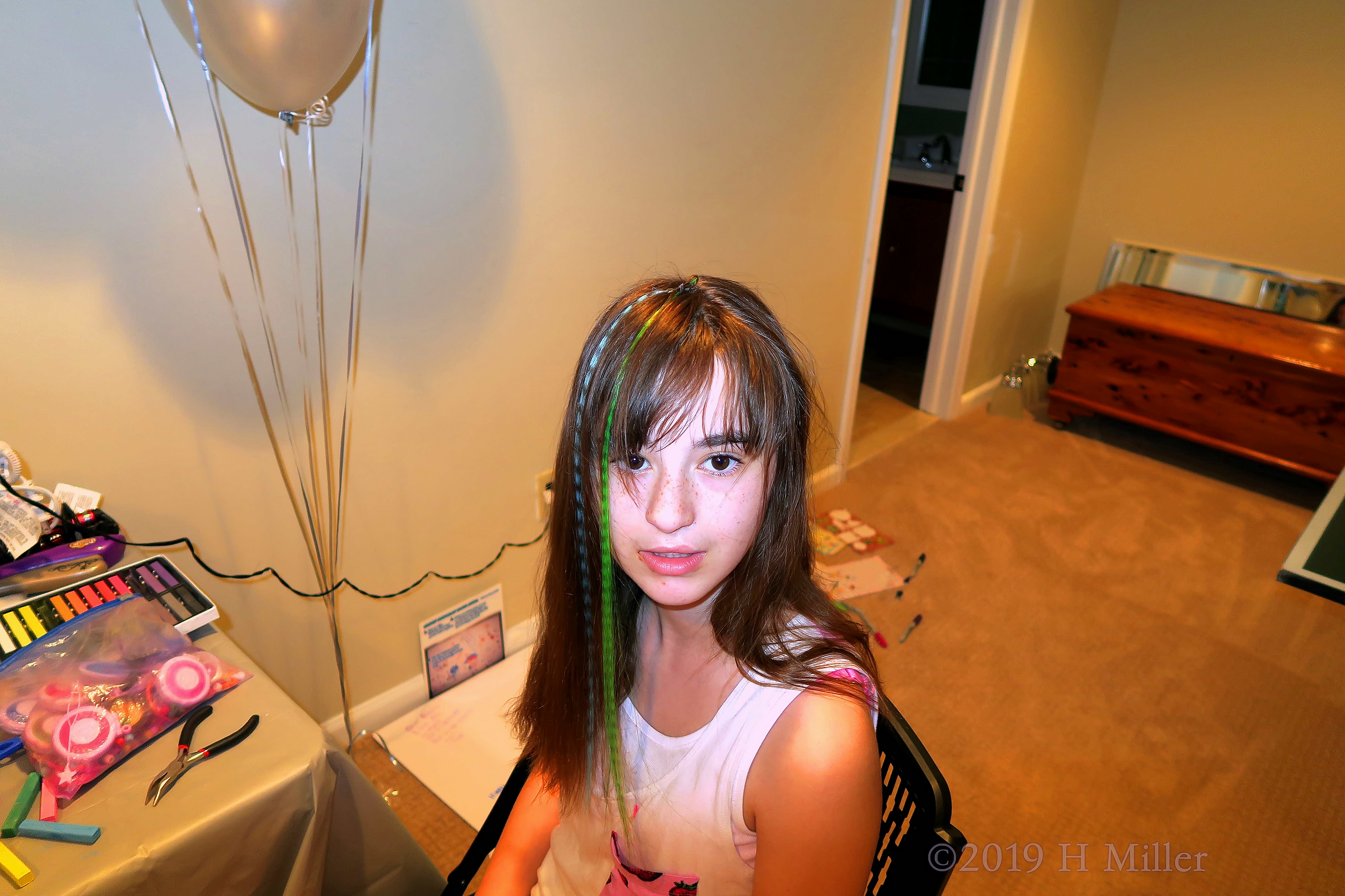 Girl Showing Off Multicolor Blue And Green Hair Feathers. Girl Showing Off Multicolor Blue And Green Hair Feathers.