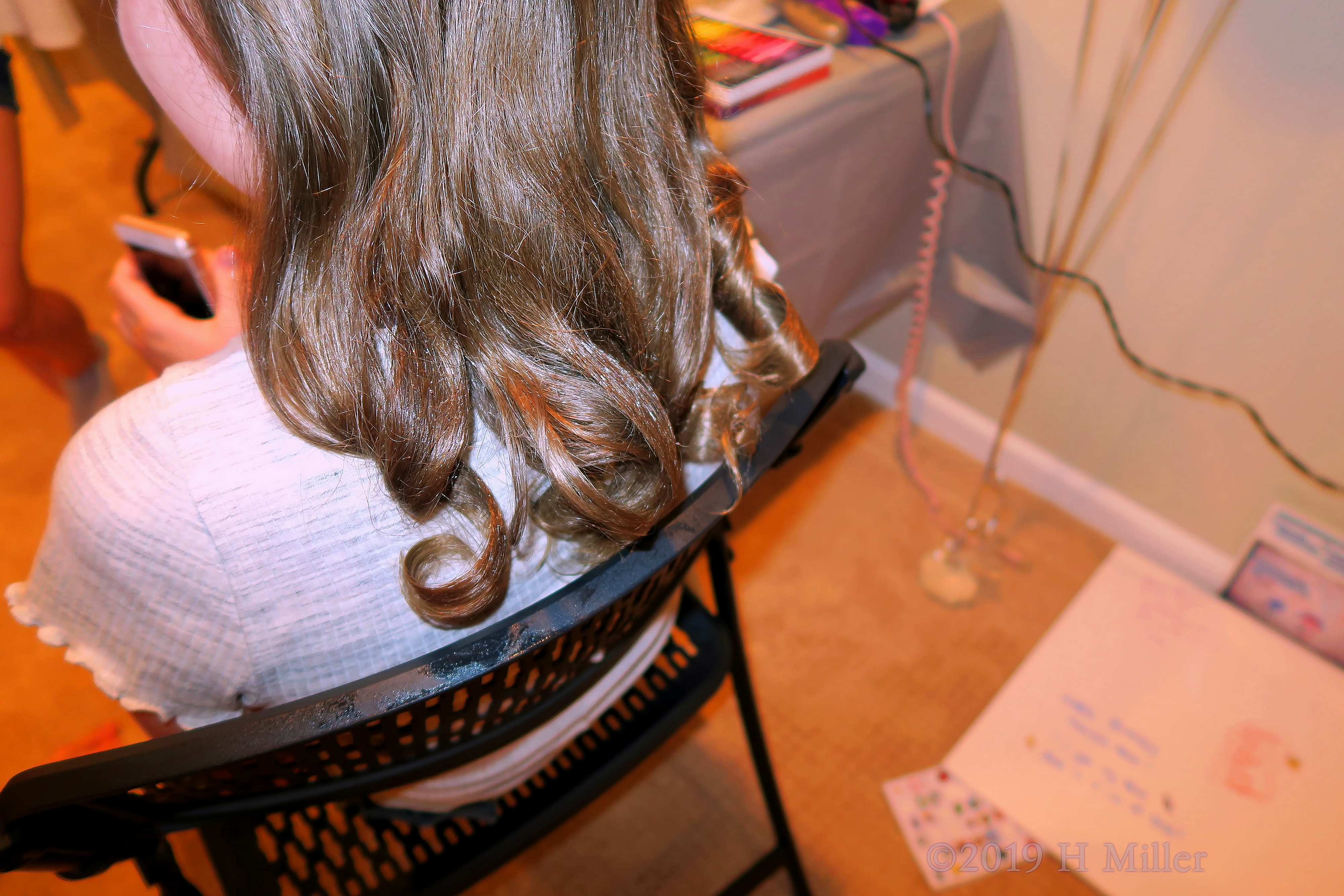 Girl Showing Off Pretty Curled Girls Hairstyle. Girl Showing Off Pretty Curled Girls Hairstyle.