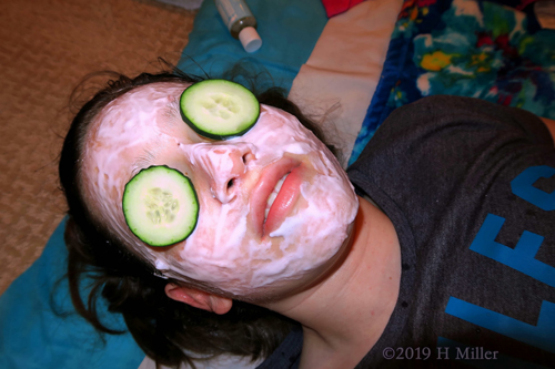 Kids Facial Mask With Cucumber Slices Over The Eyes