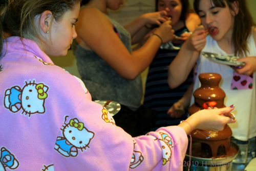 Mackenzie Standing Around Chocolate Fountain Eating Snacks With Friend Mackenzie Standing Around Chocolate Fountain Eating Snacks With Friend