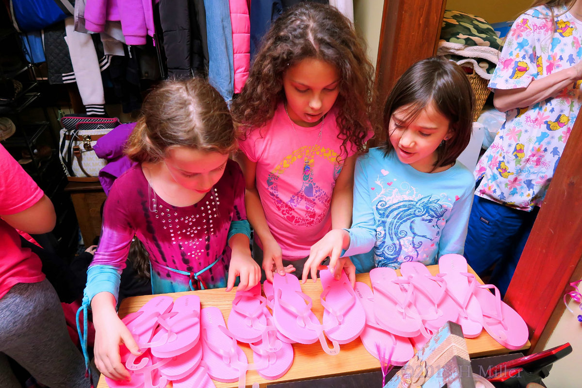 3 Girls Look At The Many Different Flipflops To Wear At The Spa Party For Girls. 