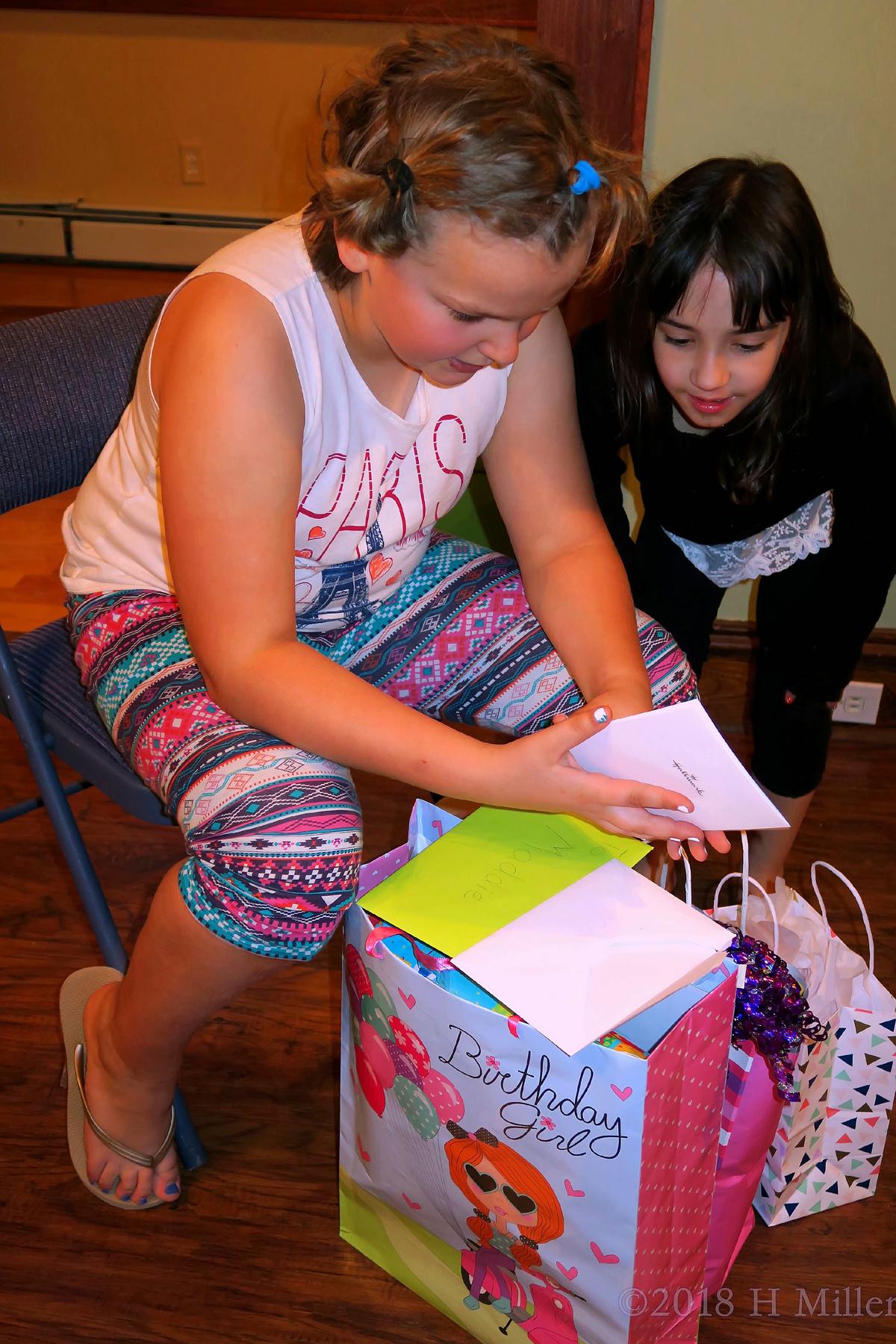 Birthday Girl Opening Card With Her Friend 