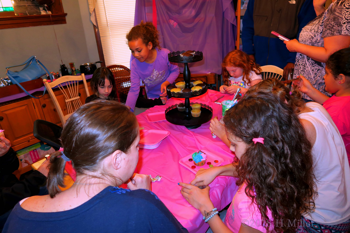 Putting The Gumdrops On The Cupcakes At The Birthday Party 