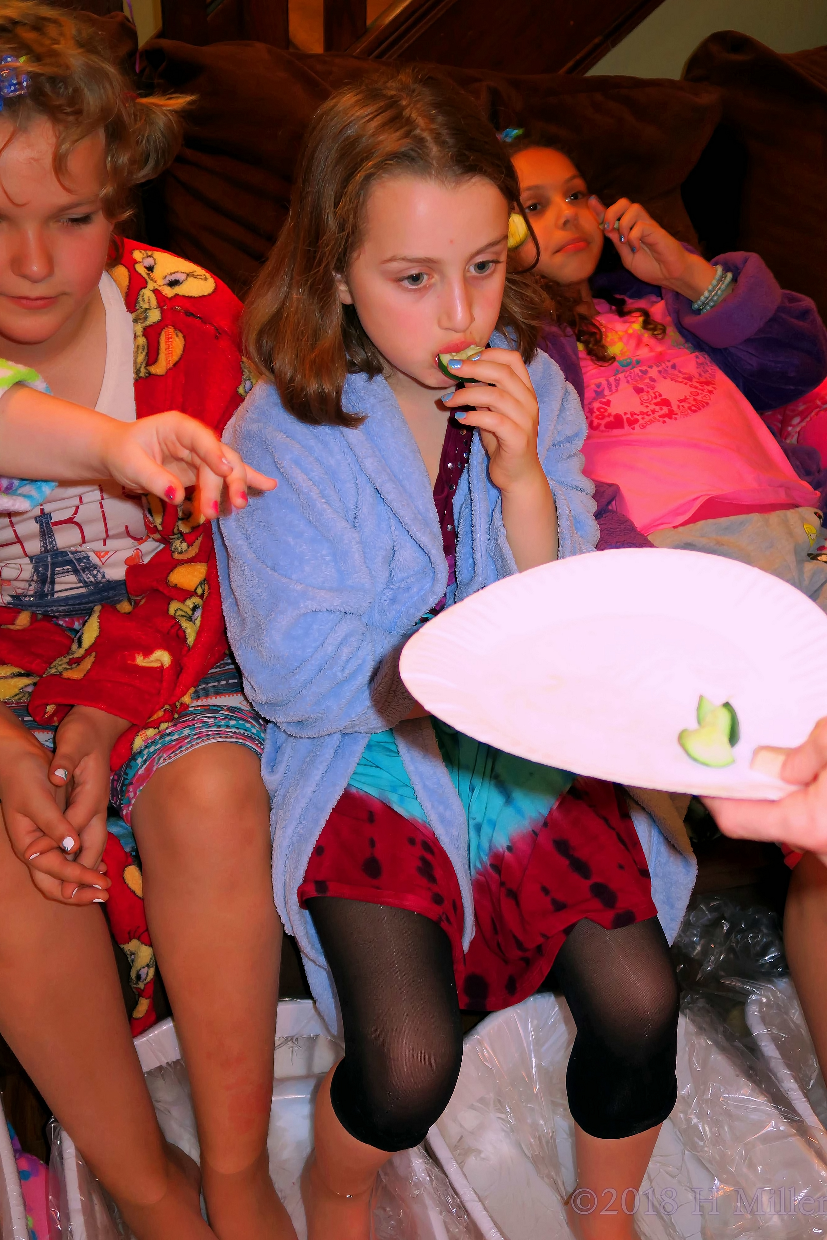 Blue Robed Spa Girl Eats Cuke Slice 
