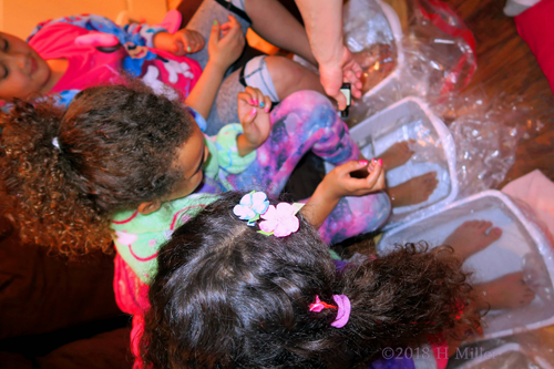 Closeup Of The Girls Dropping The Salt In The Footbaths