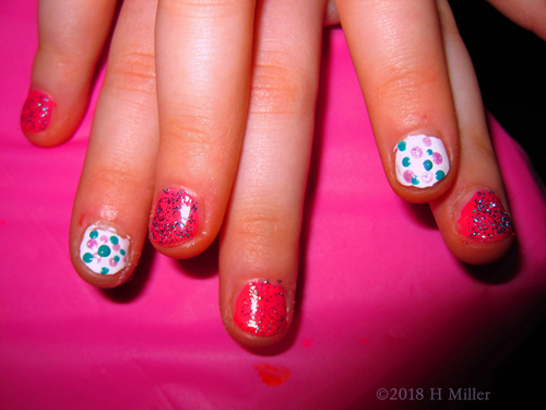 Pink And Green Polka Dots With Purple Sparkle On Pink Manicure Closeup 