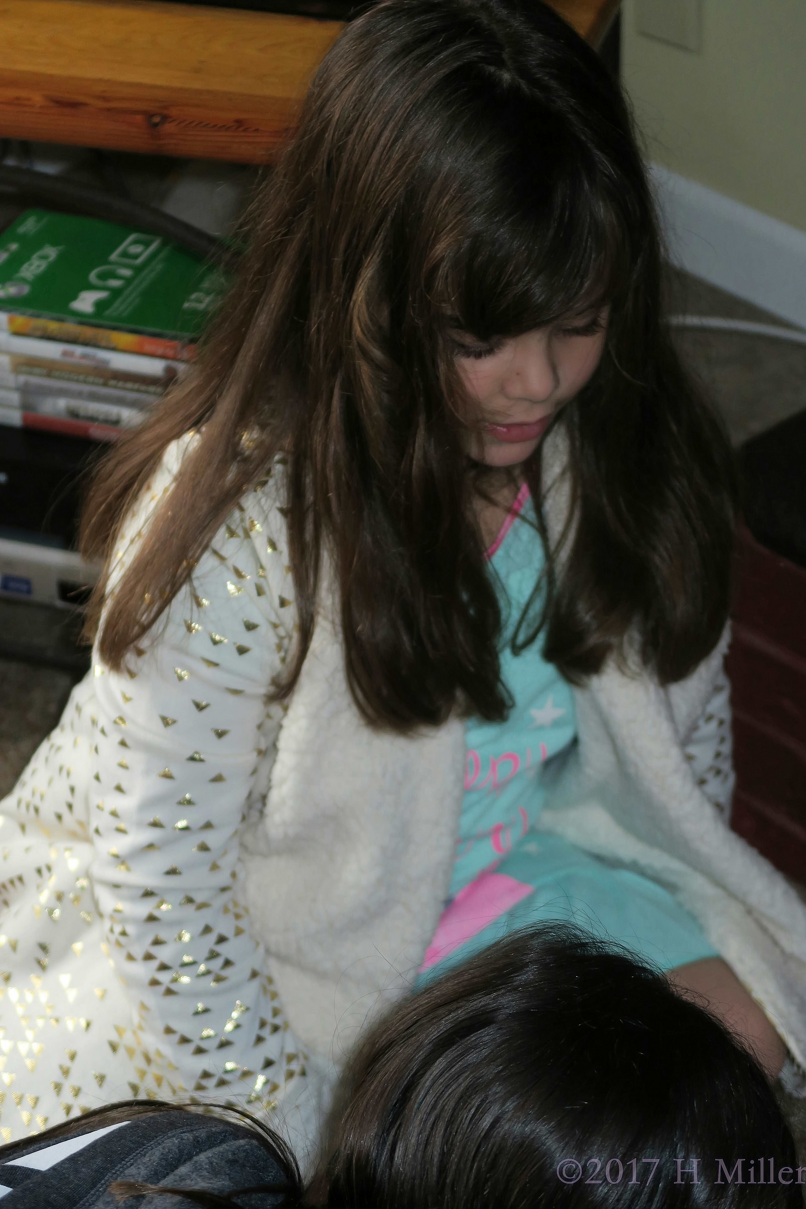 Girl Seeing What Her Friends Are Writing On The Birthday Card. Girl Seeing What Her Friends Are Writing On The Birthday Card.