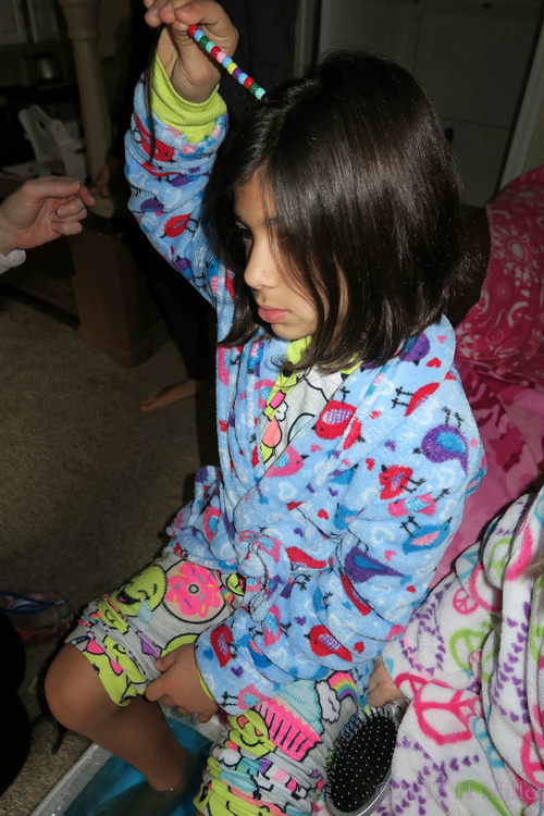 Holding Her Beaded Hair While More Beads Are Added For Her Awesome Girls Hairstyle! Holding Her Beaded Hair While More Beads Are Added For Her Awesome Girls Hairstyle!