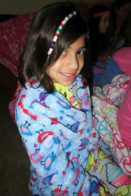 Posing For The Camera With Her Beaded Girls Hairstyle.