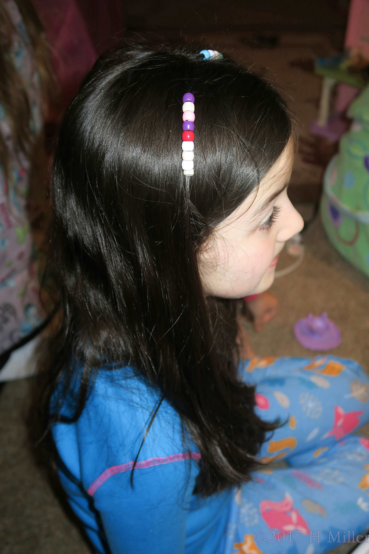 Close Up Of Her Cute Beaded Hairstyle. 