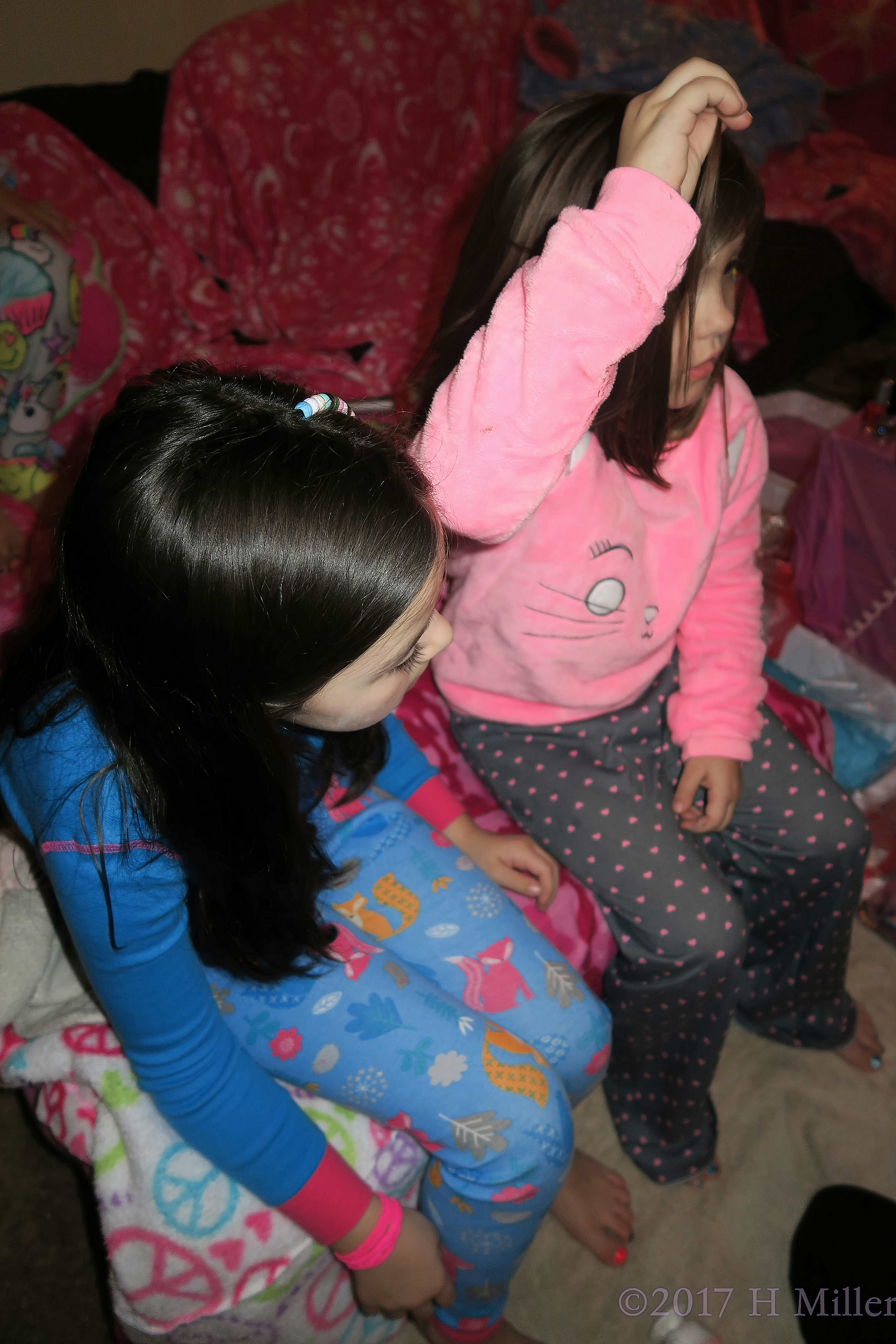 Friends Sitting Together While She Gets Her Awesome Beaded Girls Hairstyle. Friends Sitting Together While She Gets Her Awesome Beaded Girls Hairstyle.