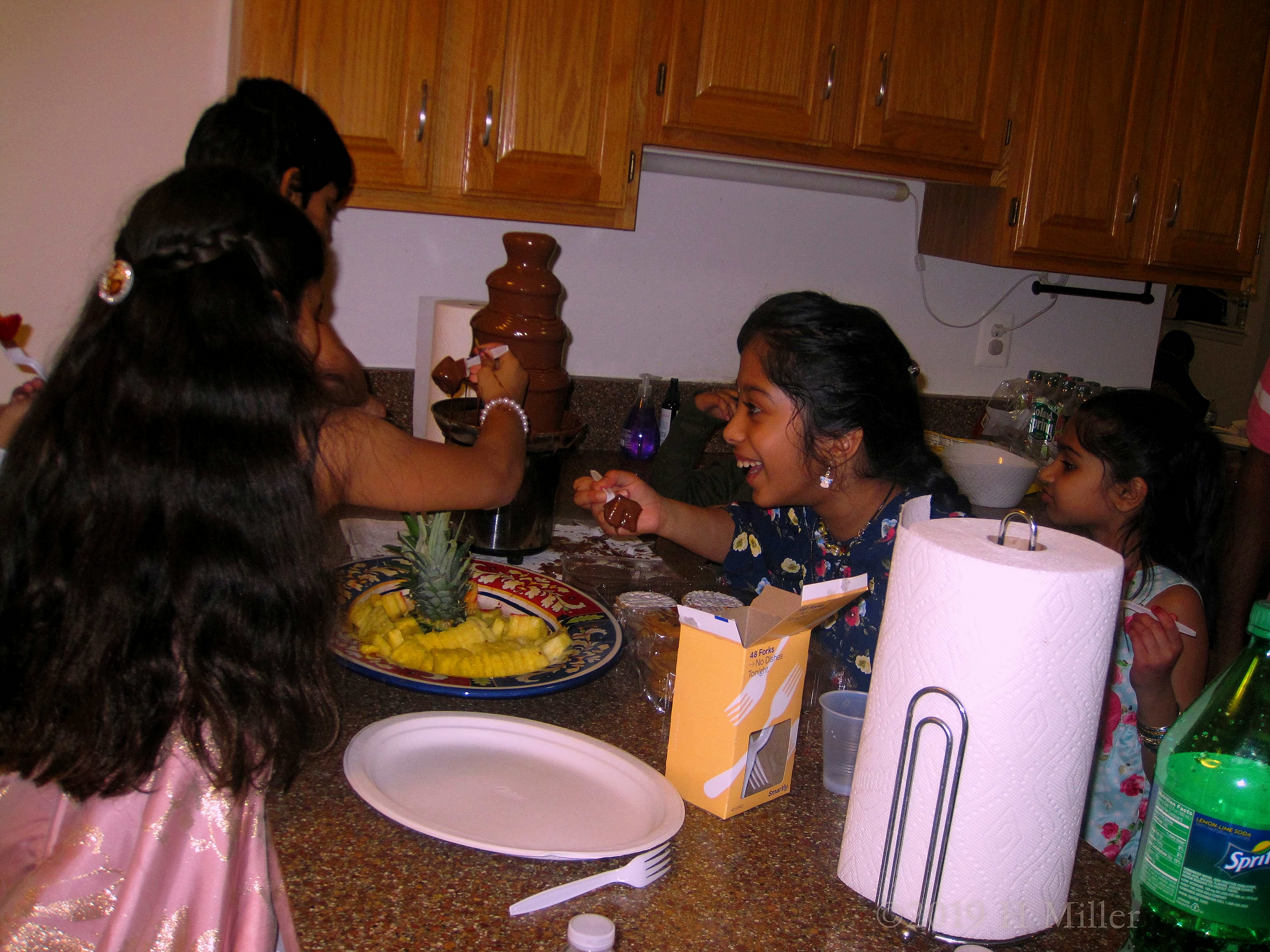 The Birthday Guests Are Enjoying The Chocolate Fountain 