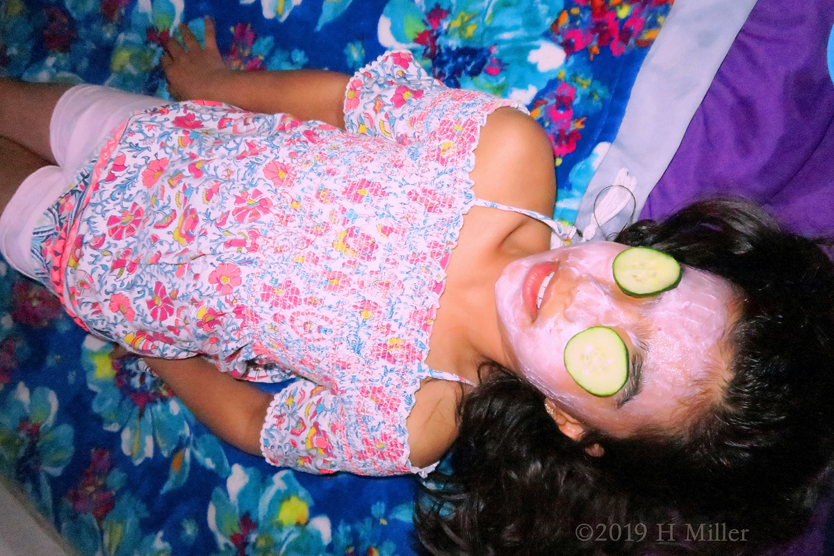 Smiling With Cukes On Her Eyes During Girls Facials 