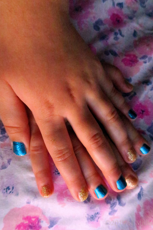 A Close Shot Of Deep Turquoise And Gold Alternating Kids Manicure