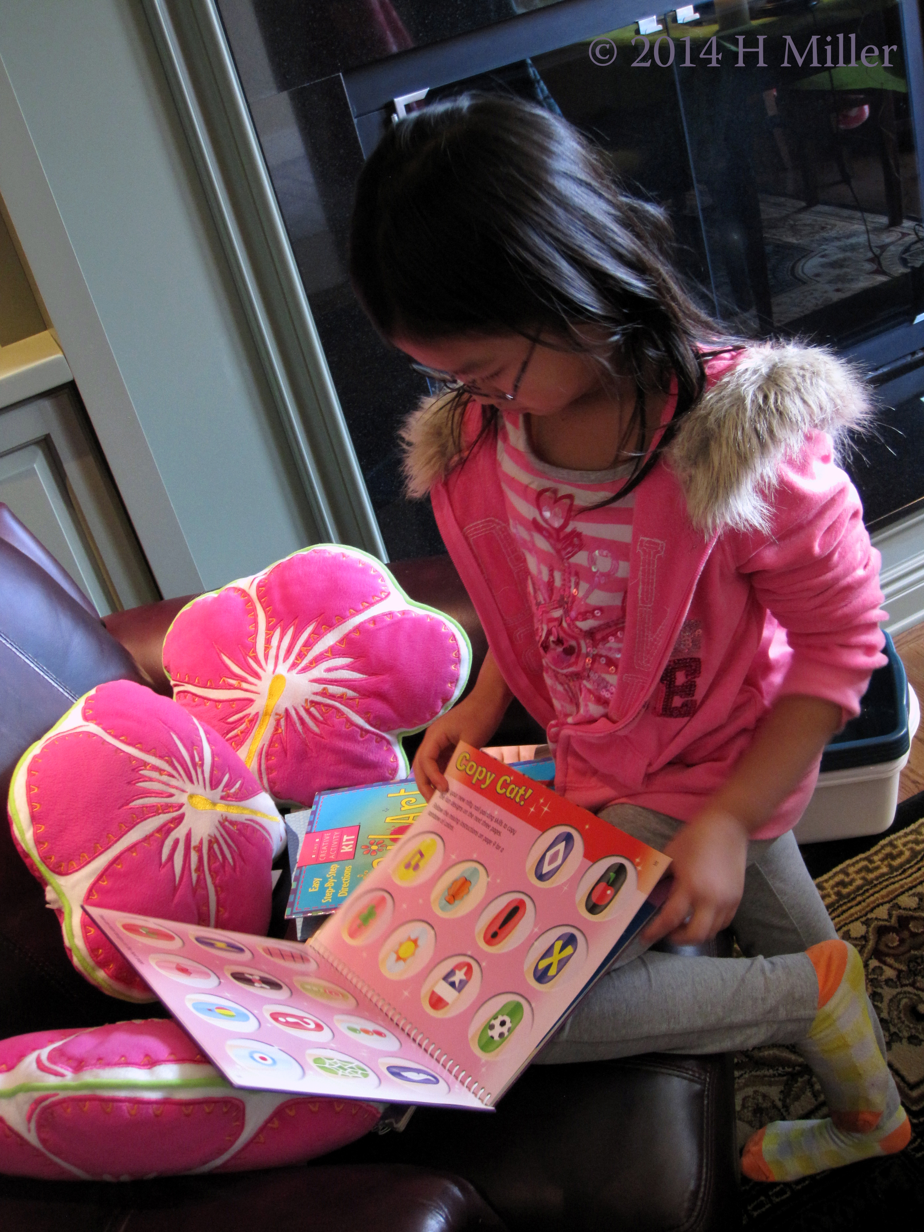 Spa Party Guest Considering Nail Art Designs In Book Spa Party Guest Considering Nail Art Designs In Book