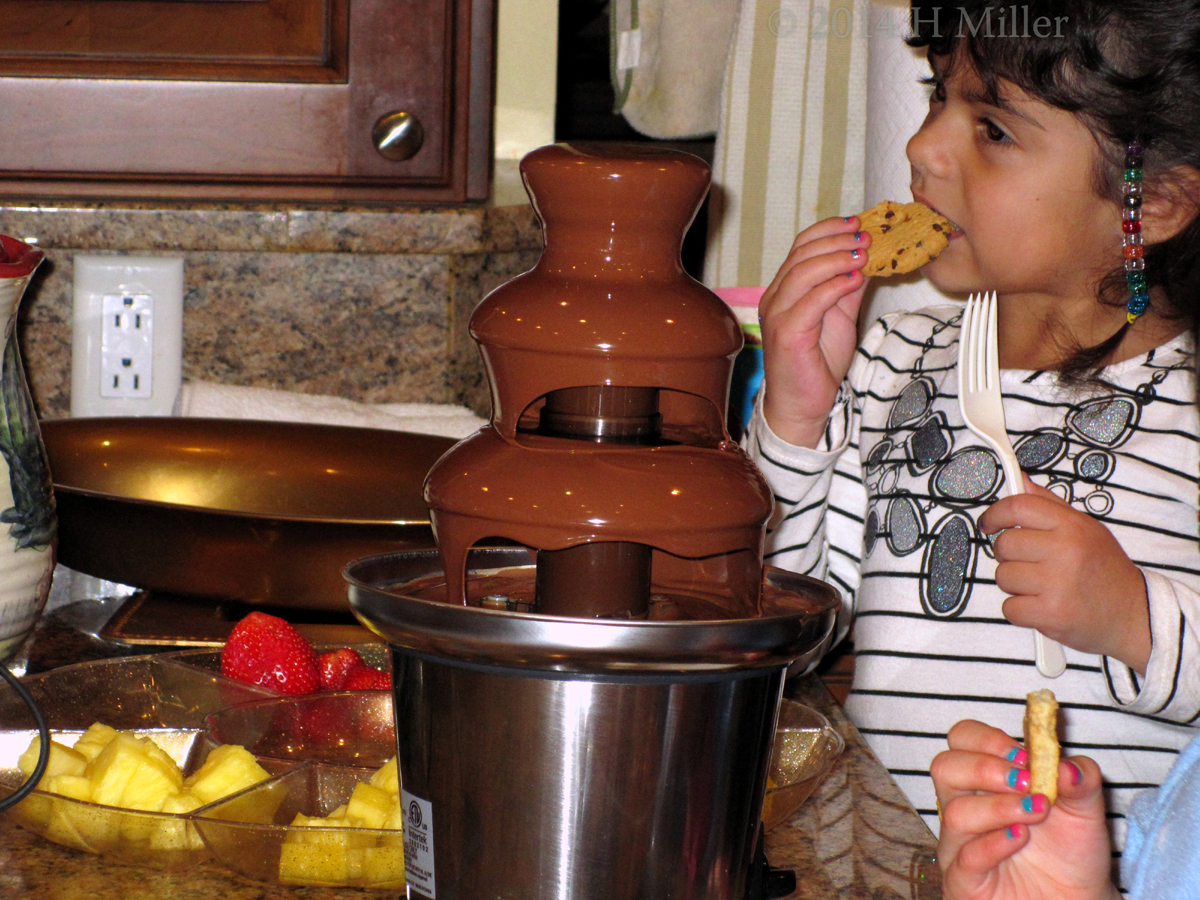 Kids Spa Party Chocolate Fondue Fountain And Guest Eating Cookie Dipped Kids Spa Party Chocolate Fondue Fountain And Guest Eating Cookie Dipped