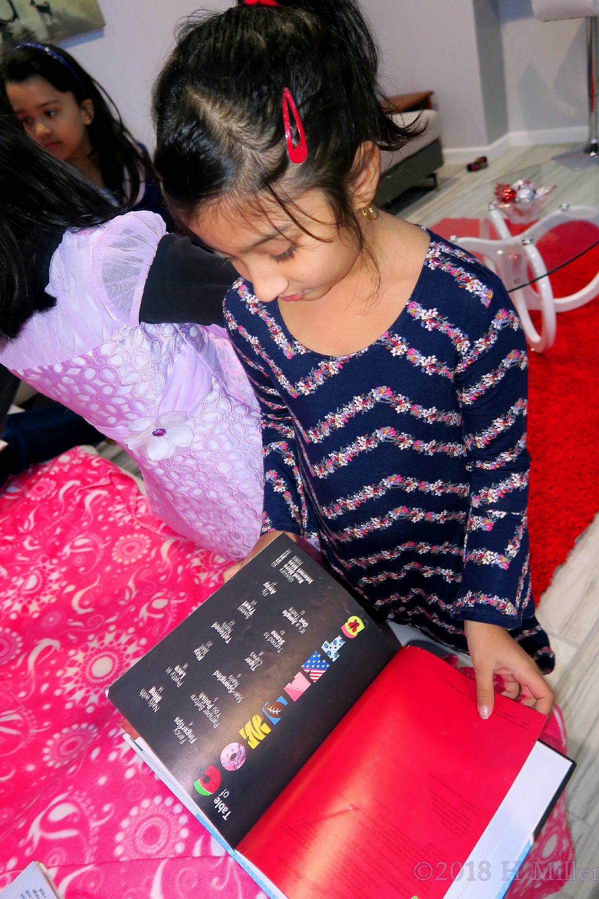 Party Guest Checking Out Nail Art Book For Ideas For Her Mini Mani 