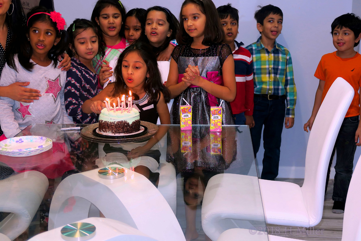 Party Guests Gather Around The Birthday Girl 