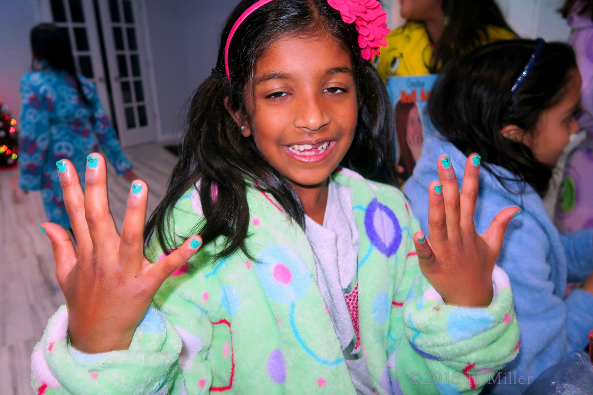 Showing Off Her Electric Blue Kids Manicure With PolkaDot Nail Design Overlay 