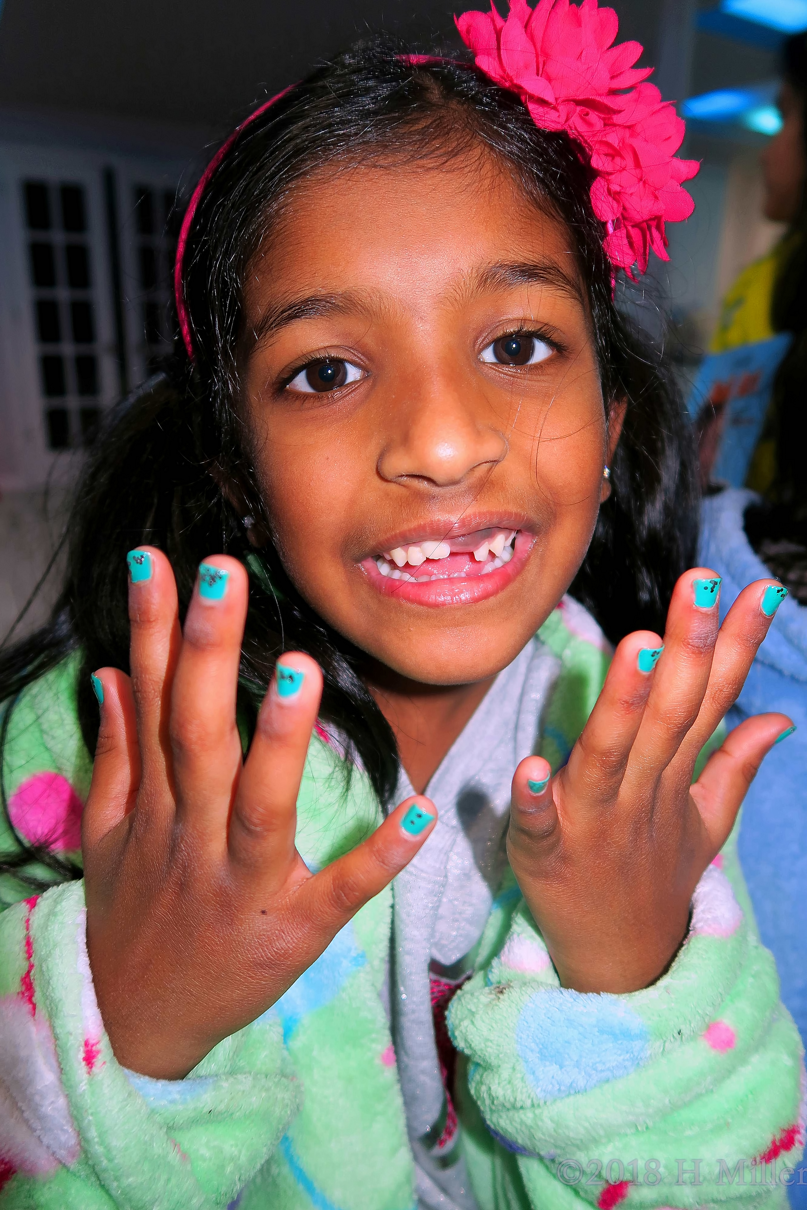 Close Up Photo Of Her Glittery Girls Manicure. 