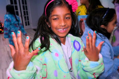 Showing Off Her Electric Blue Kids Manicure With PolkaDot Nail Design Overlay