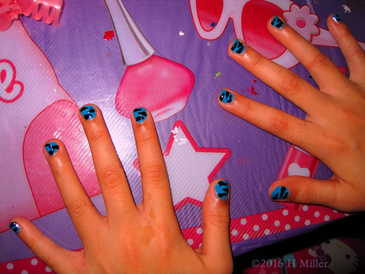 Blue Background With Black Zebra Stripes Nail Design On This Kids Manicure 