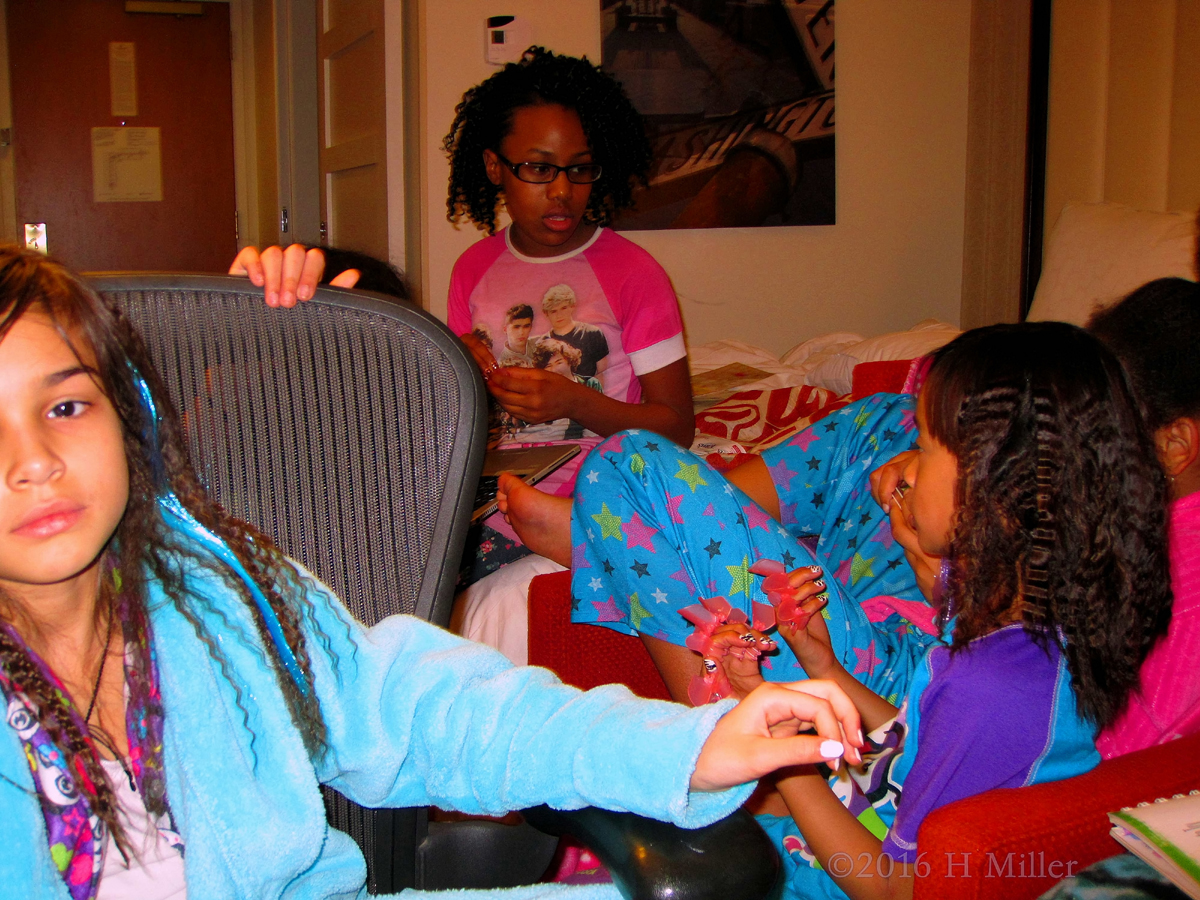 Three Spa Friends Waiting For Their Kids Manicure To Be Done 