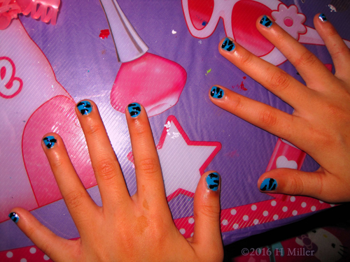 Blue Background With Black Zebra Stripes Nail Design On This Kids Manicure