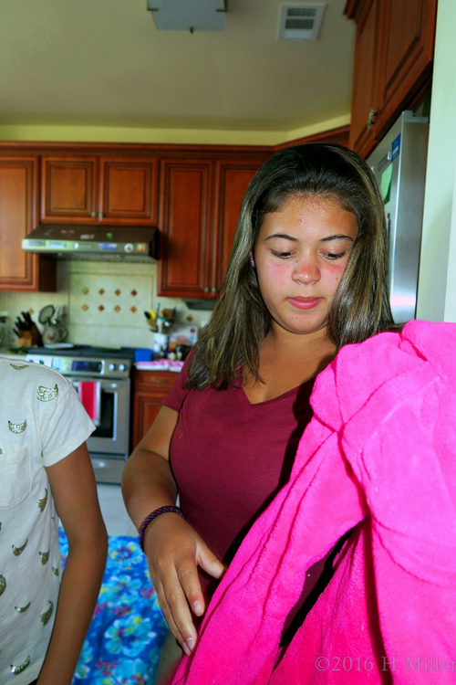 Putting On A Pink Spa Robe.