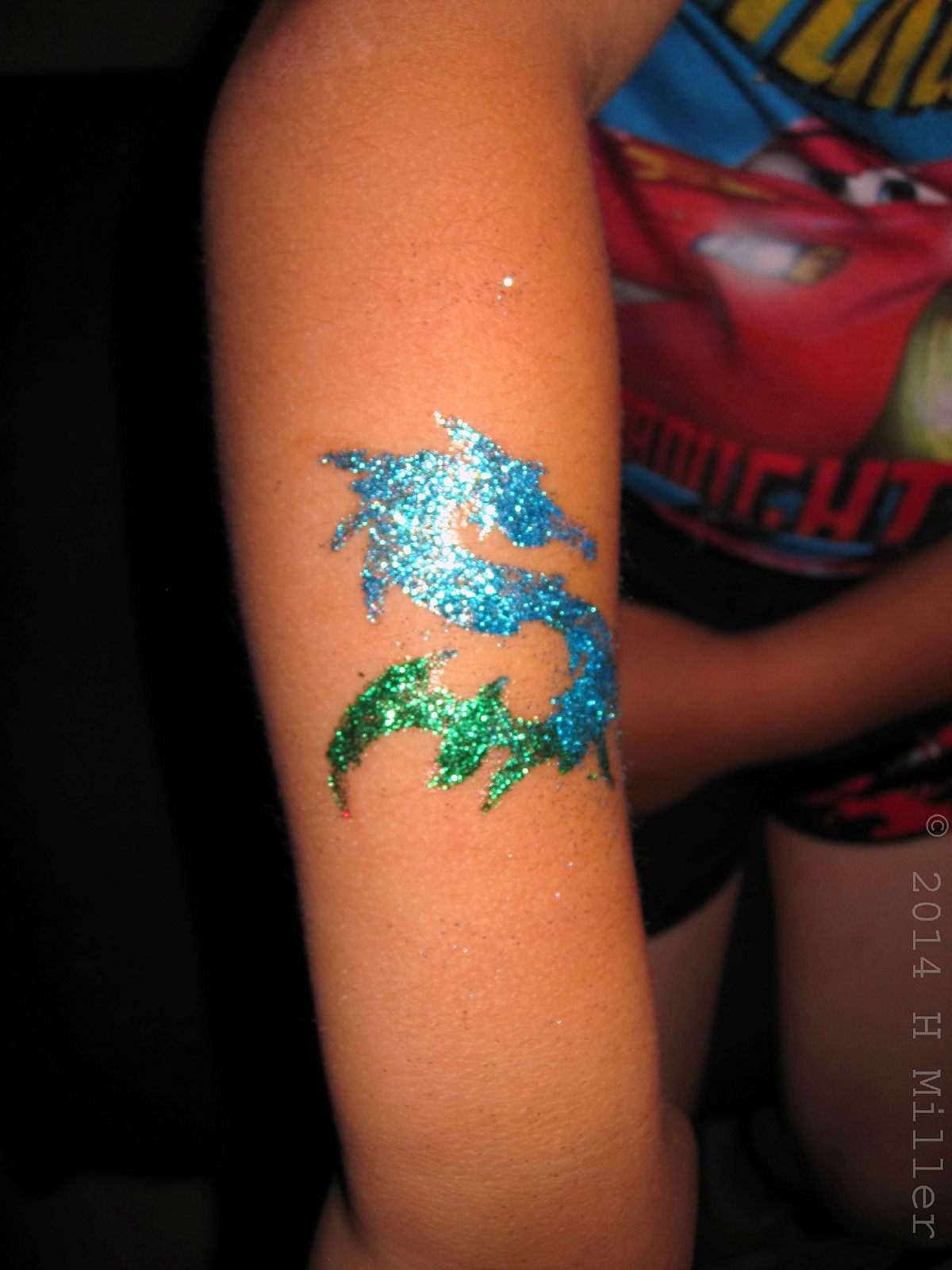 Colorful Dragon Kids Body Glitter Art Closeup View. 