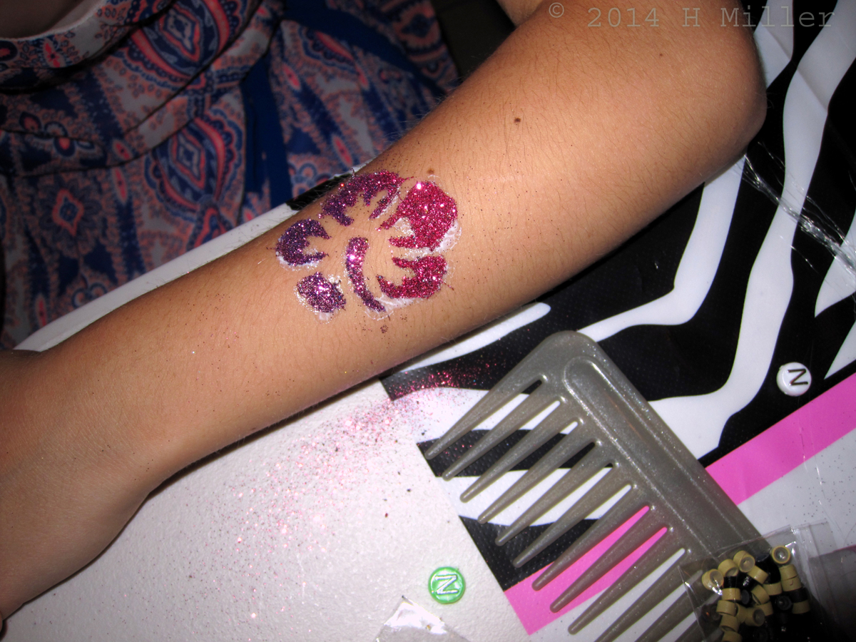 This Body Glitter Design Was Done In Red And Purple. 