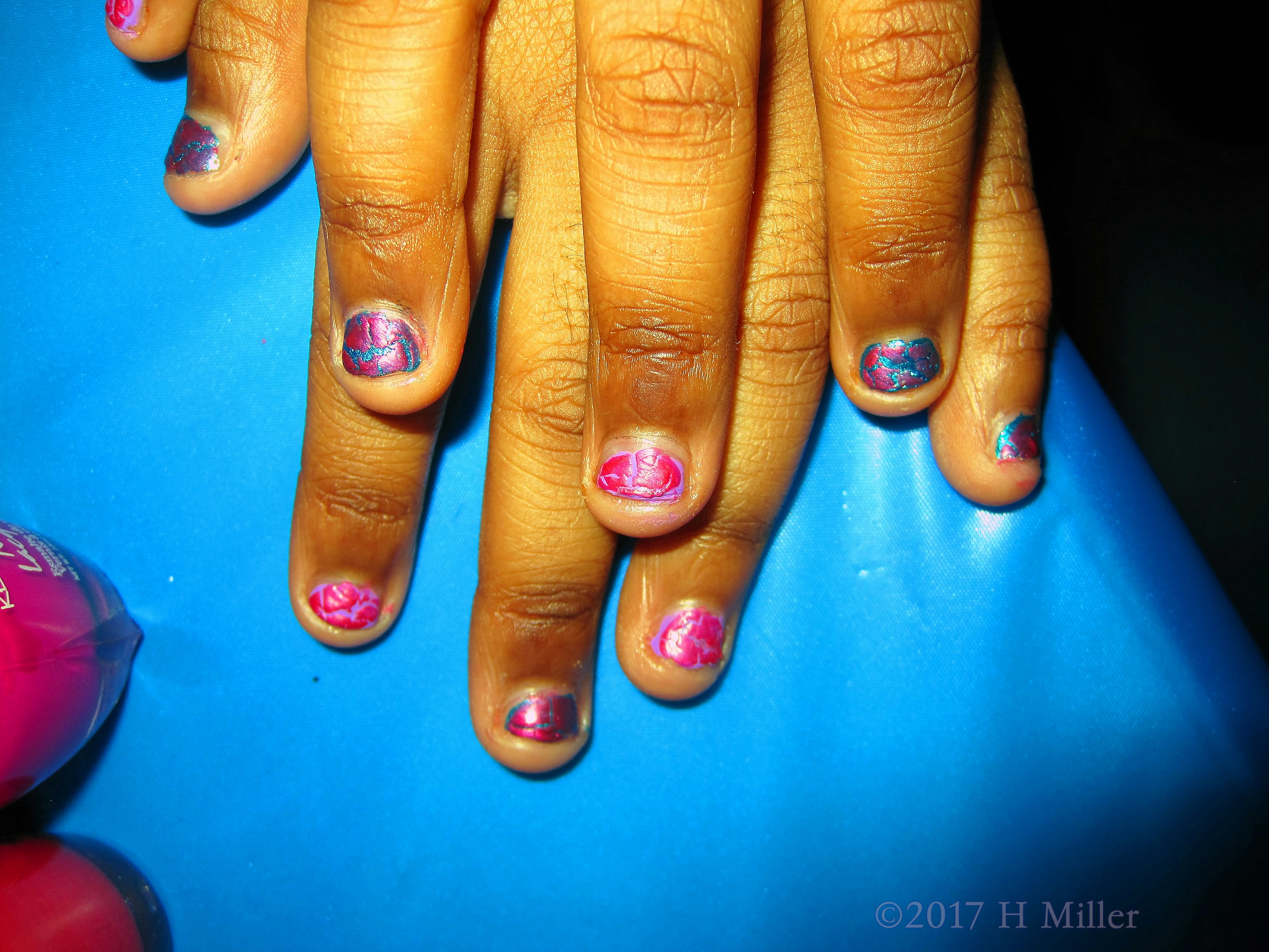 Alternating Pink And Purple Nail Polish For This Girls Manicure.