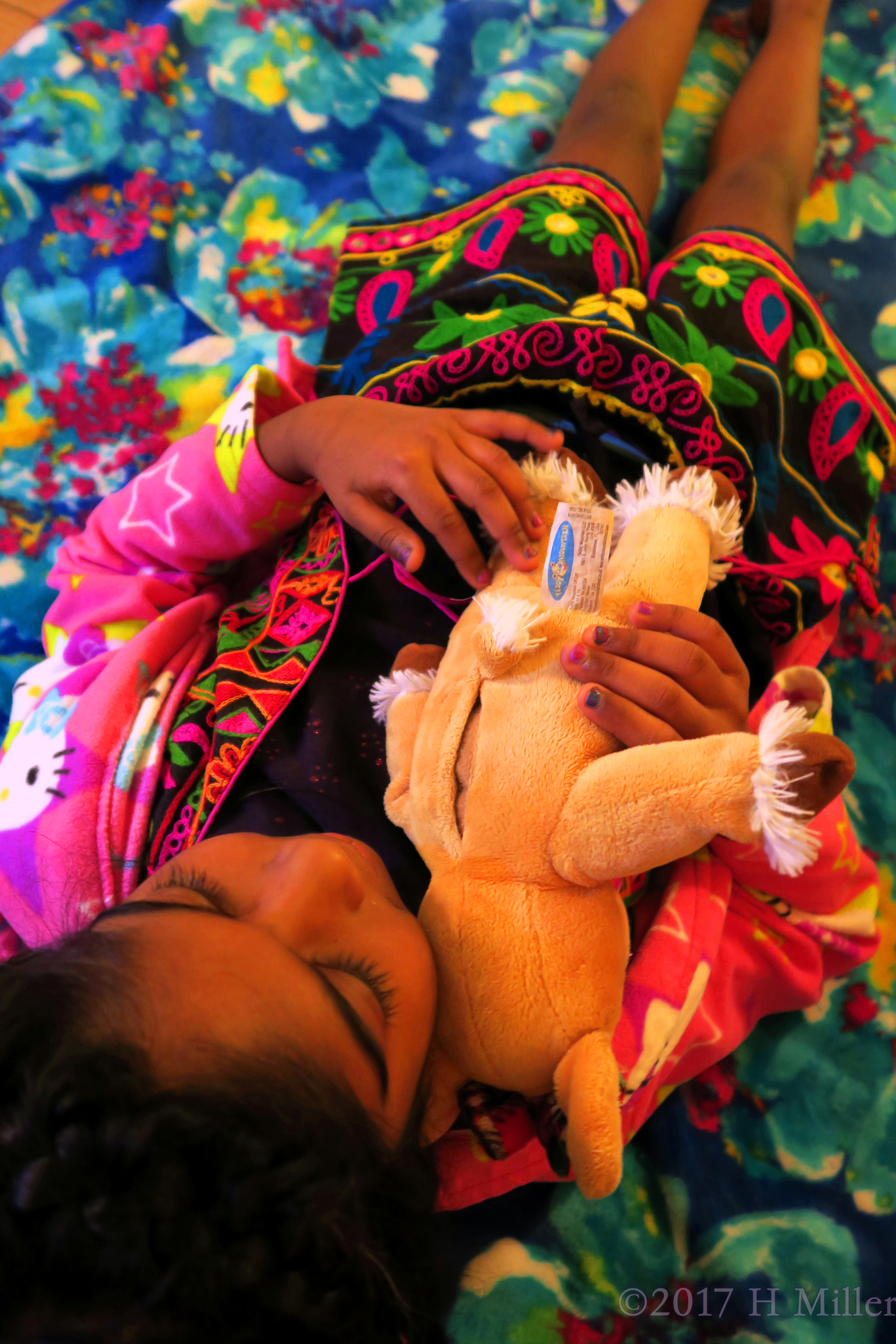 Cuddling Her Stuffed Animal While Getting Her Kids Facial. Cuddling Her Stuffed Animal While Getting Her Kids Facial.