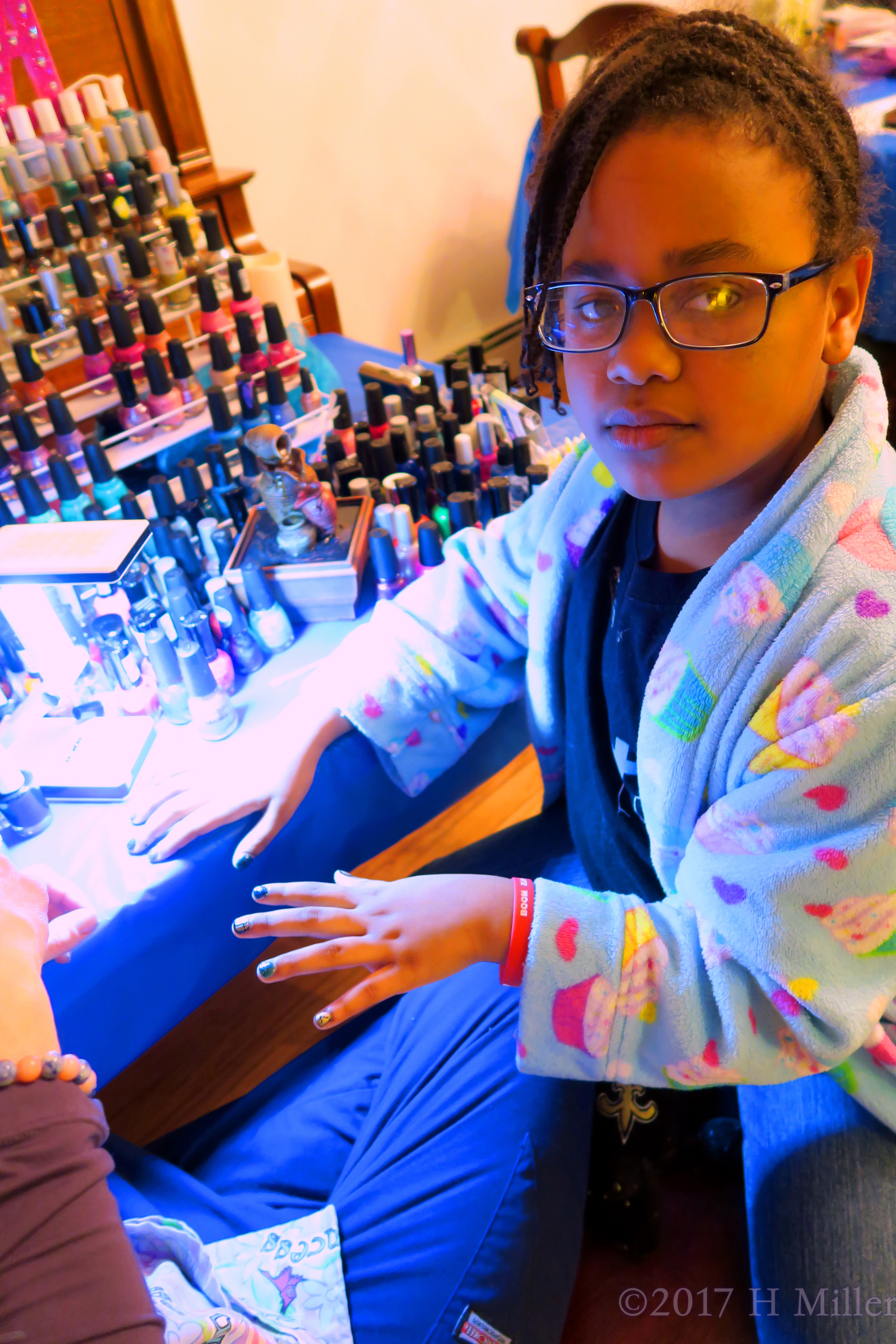 Looking At The Camera During Her Kids Manicure. Looking At The Camera During Her Kids Manicure.