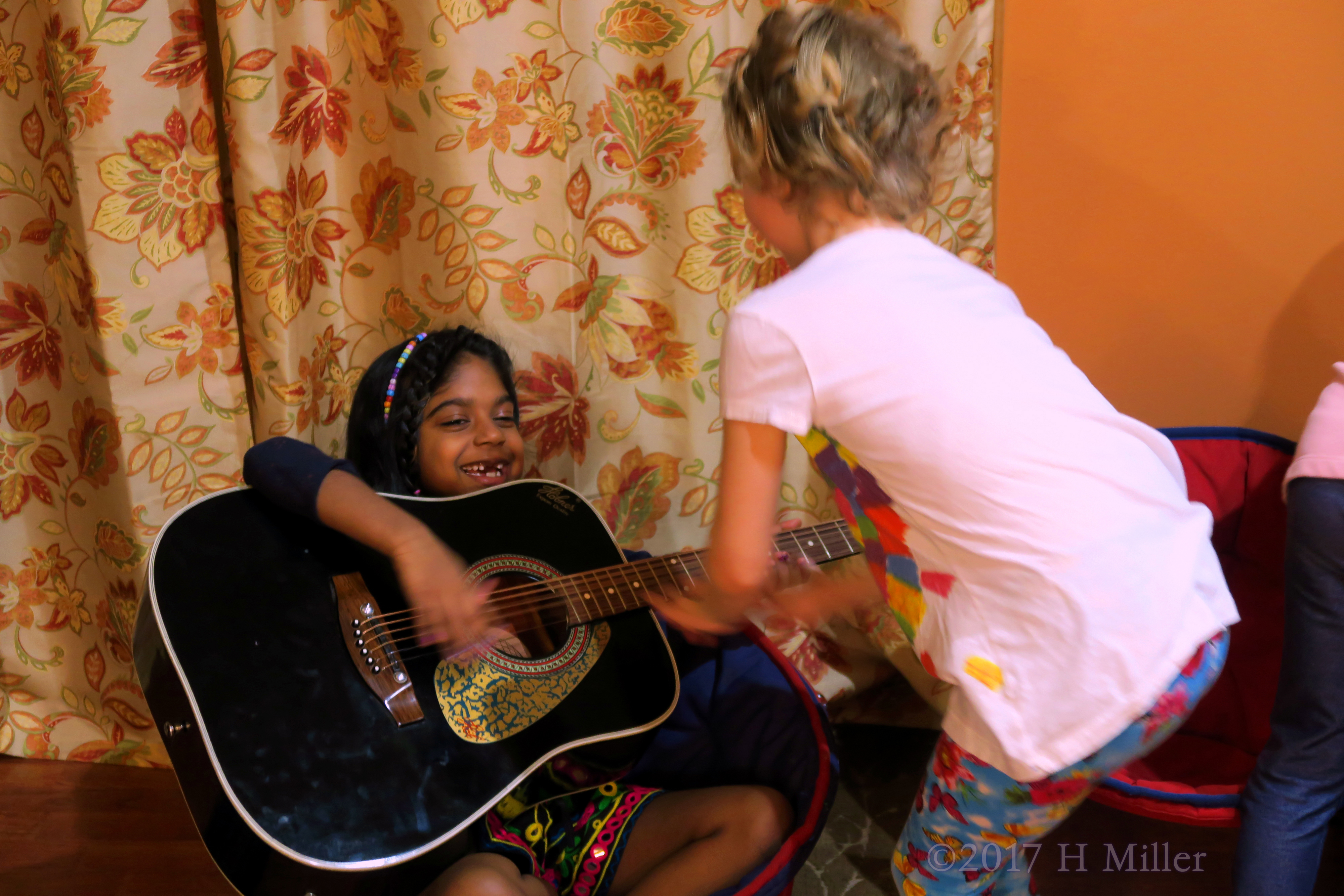 Playing Her Dad'd Guitar. Playing Her Dad'd Guitar.