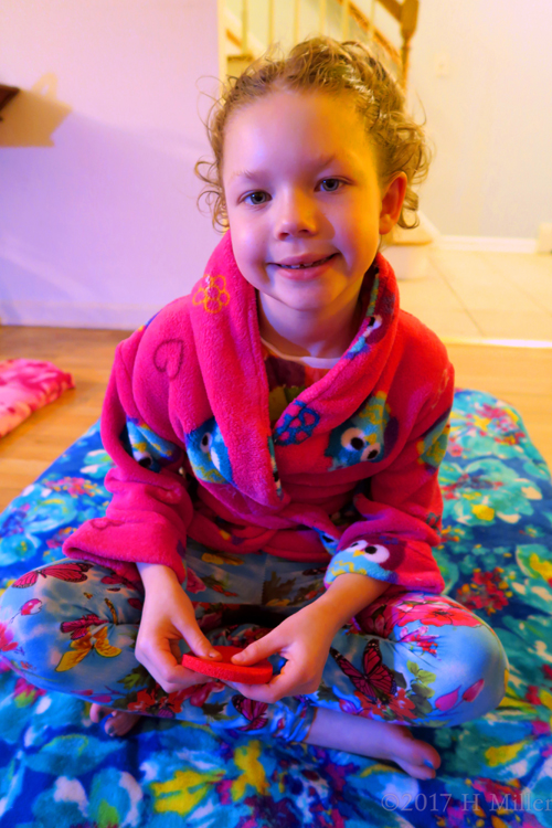 Holding Her Kids Facial Sponge, With Glowing Skin After The Facial