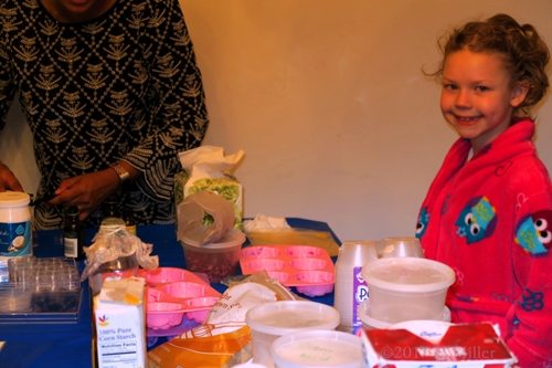 Smiling While Making Lip Balm Kids Crafts At The Spa For Girls.