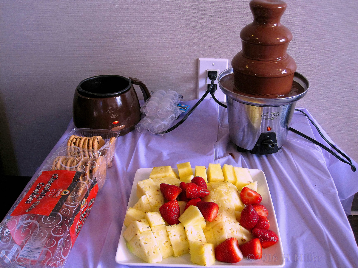 Chocolate Fondue Fountain And Fruit Snacks For The Kids Party.