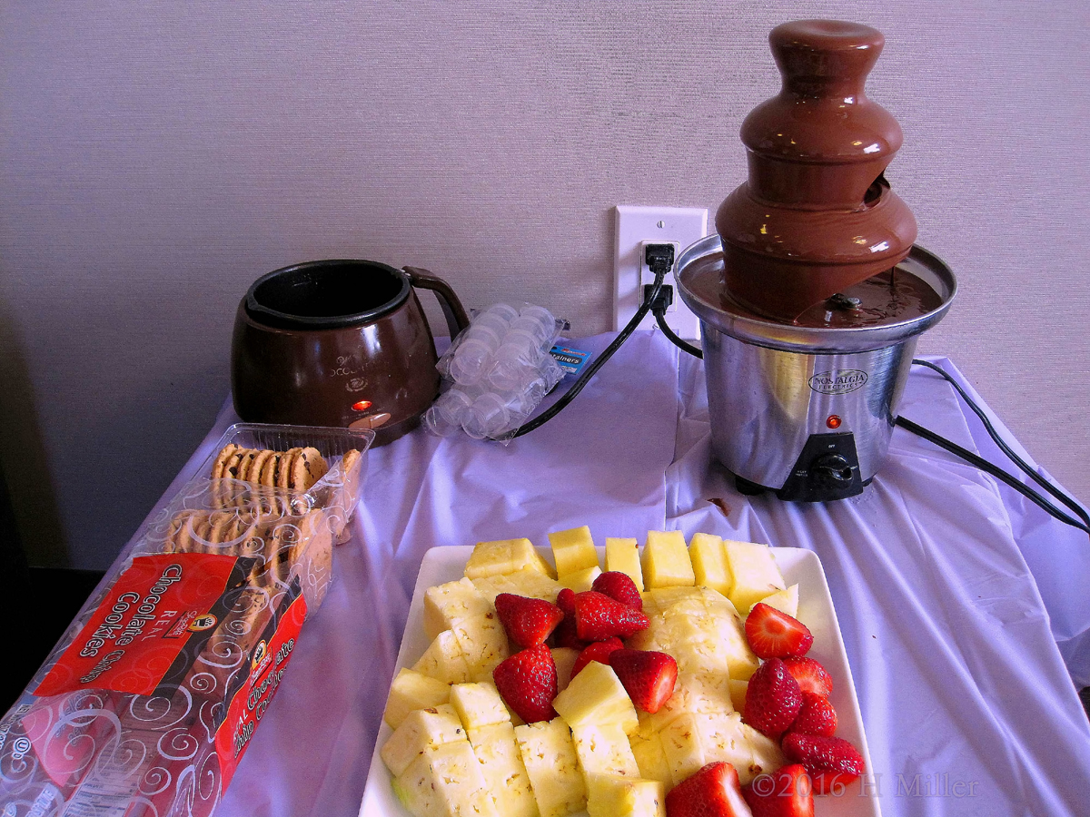 Chocolate Fondue Fountain With Pineapples, Strawberries, And Cookies For The Spa Party For Kids.