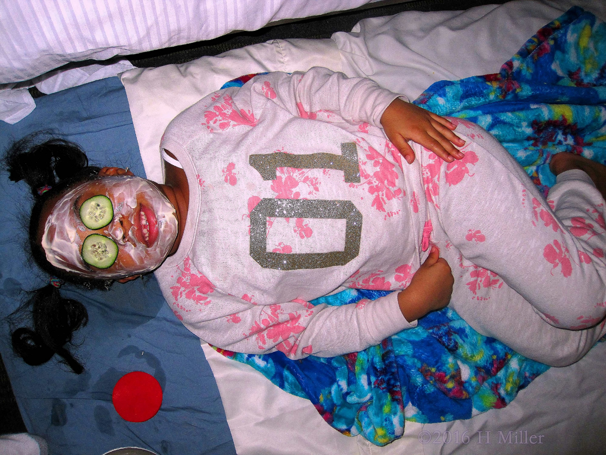 Relaxing And Smiling During Her Facial With Cukes On Her Eyes. 