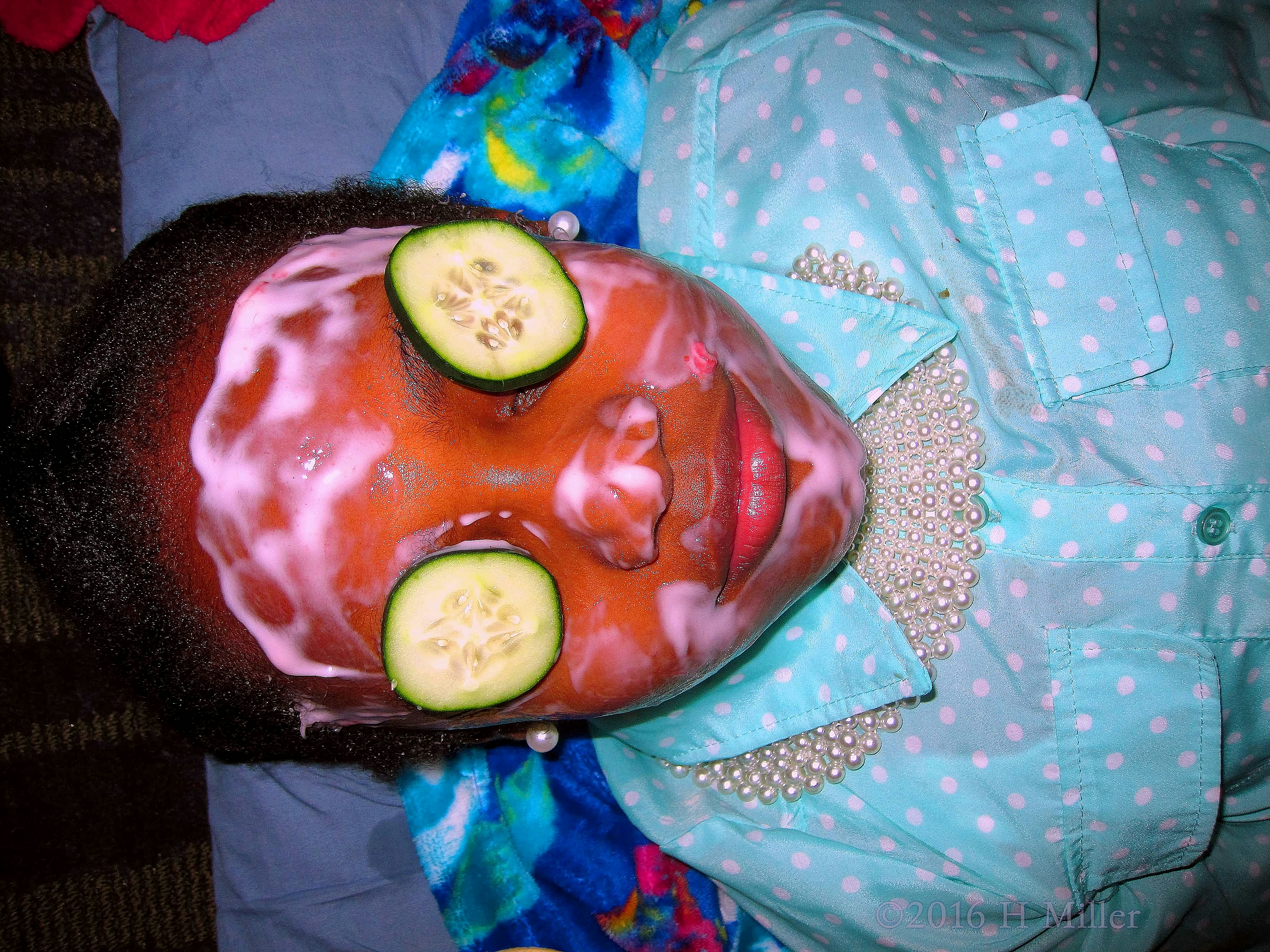 Close View Of Kids Facial With Cukes On Her Eyes. 