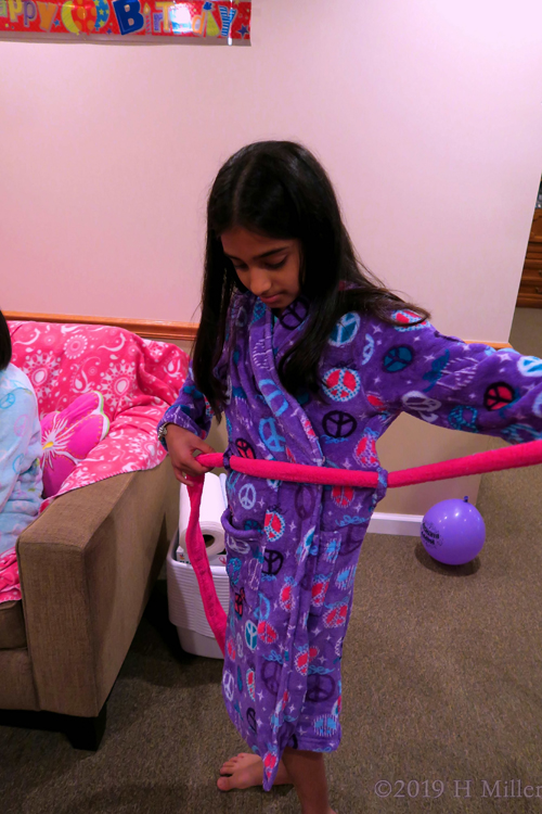 This Spa Guest Is Having Fun Putting On A Purple Spa Robe This Spa Guest Is Having Fun Putting On A Purple Spa Robe