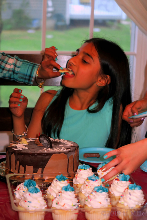 The Birthday Girl Is Taking A Bite Of Yummy Snacks The Birthday Girl Is Taking A Bite Of Yummy Snacks