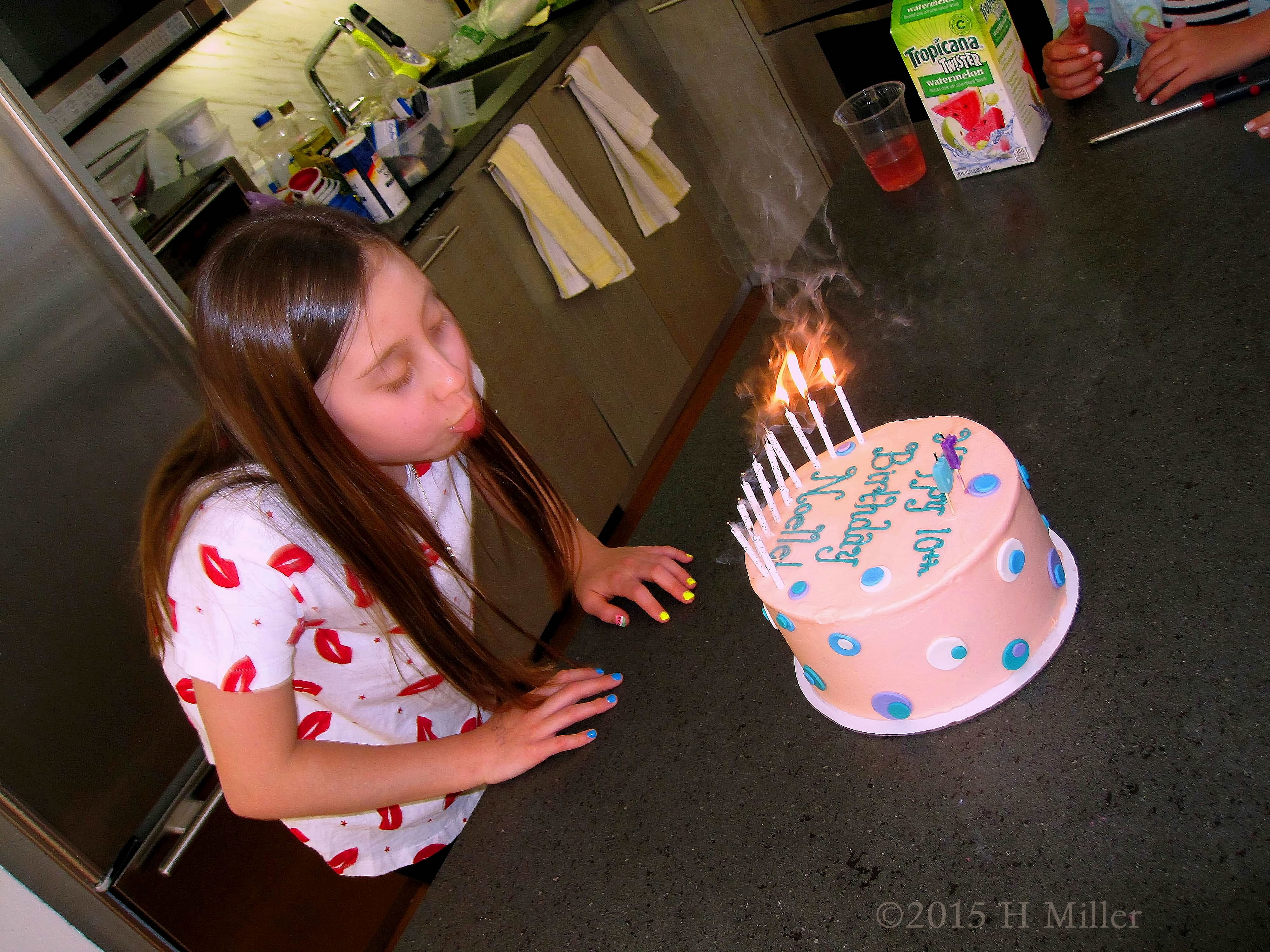 Blowing Out The Candles At Her 10th Spa Birthday Party. 