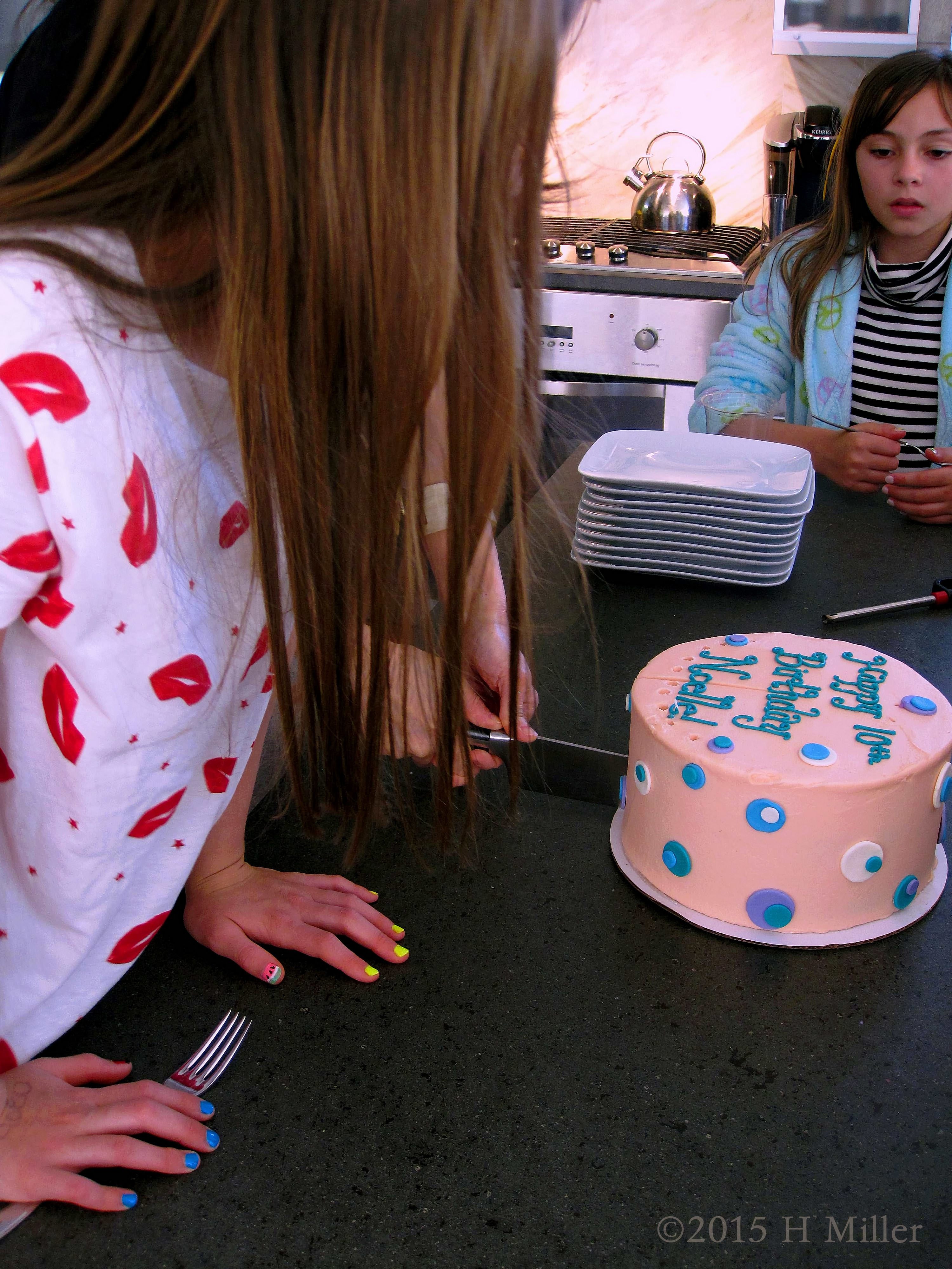 The Birthday Girl And Guests Watch As Mom Cuts The Cake. The Birthday Girl And Guests Watch As Mom Cuts The Cake.
