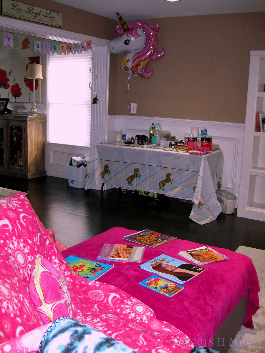Well Arranged Manicure Books And Kids Crafts Table, With A Pretty Unicorn Balloon Adding To The Party Atmosphere. 