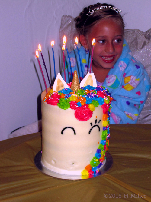 Candid Capture Of Birthday Girl With Her Unicorn Birthday Cake.