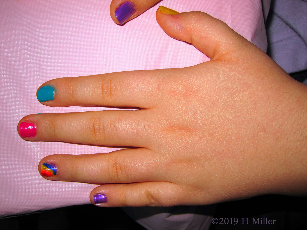 Kids Manicure In Multicolor With Blue, Pink, Yellow, Orange, And Purple, Along With A Rainbow Nail Design Accent Nail! 