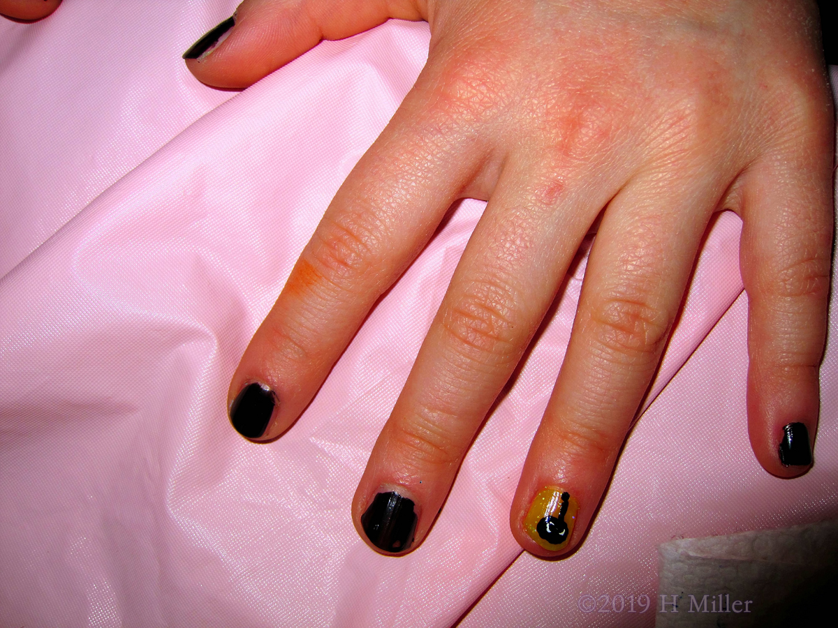 Kids Nail Art Closup On Shimmery Yellow With Black Spider Detail 