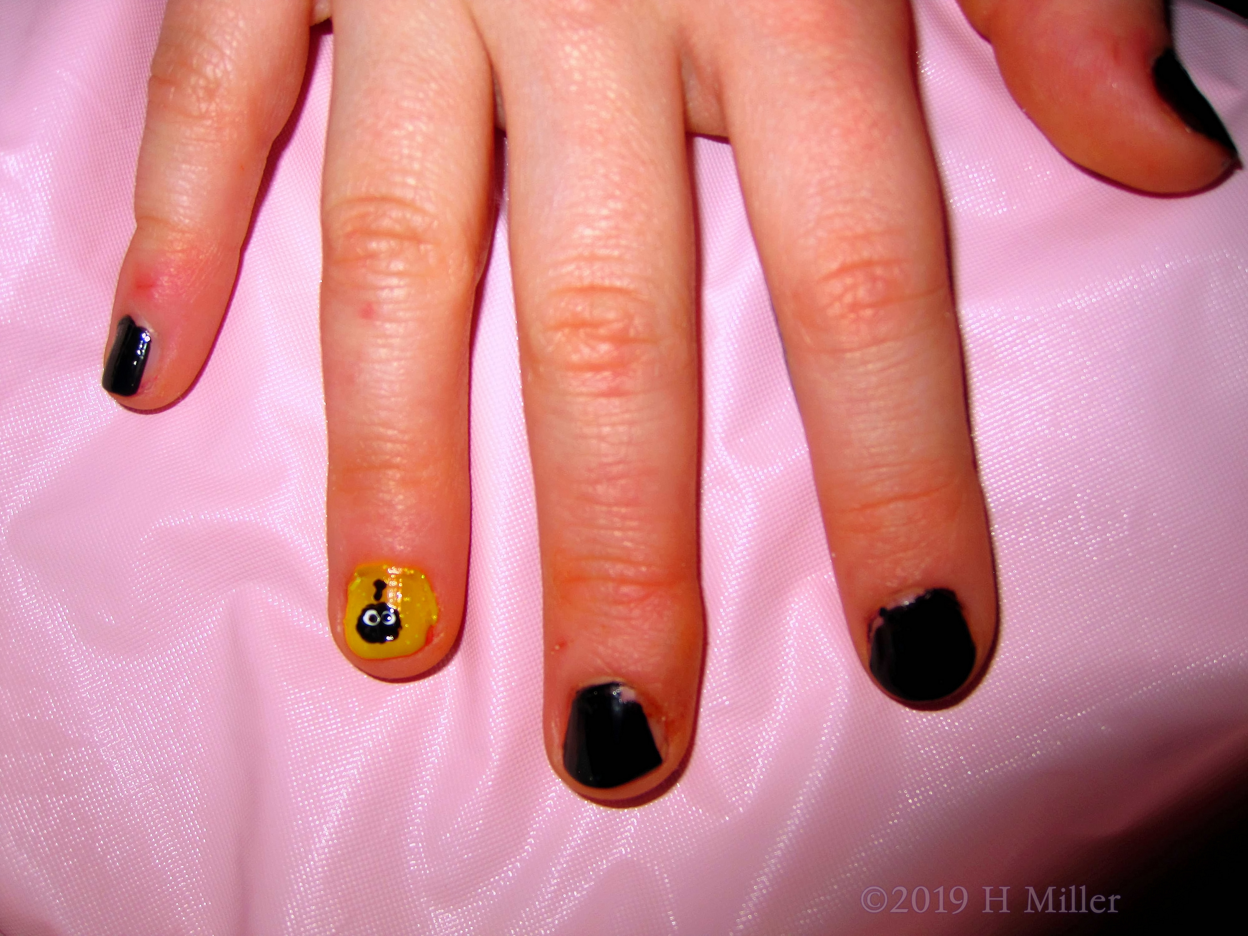 Close Up Of Shimmery Yellow And Black Nail Art 